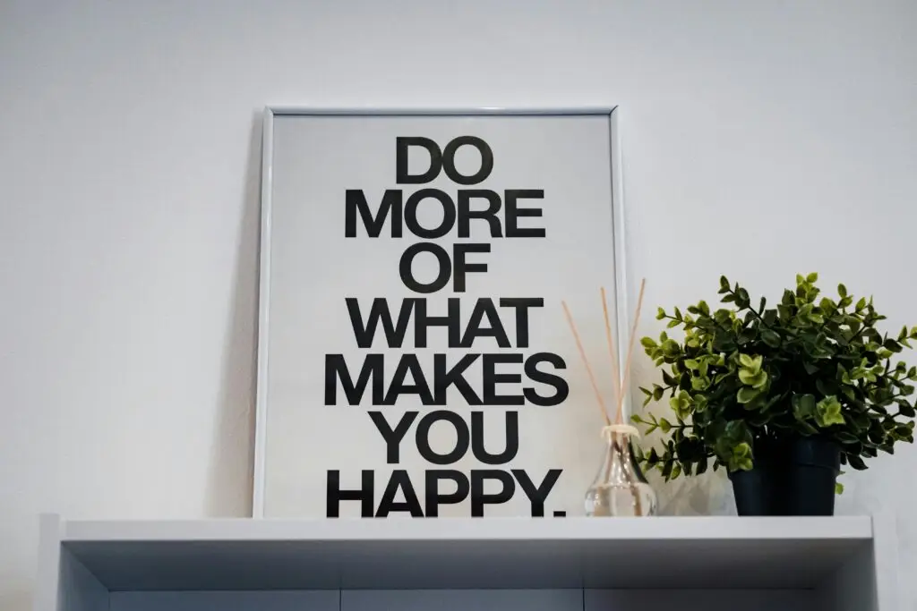 dopamine menu Framed quote 'Do More of What Makes You Happy' with plant and aroma diffuser.