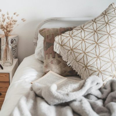 Elegant Scandinavian-style bedroom with neutral tones and cozy decor for a relaxing ambiance.
